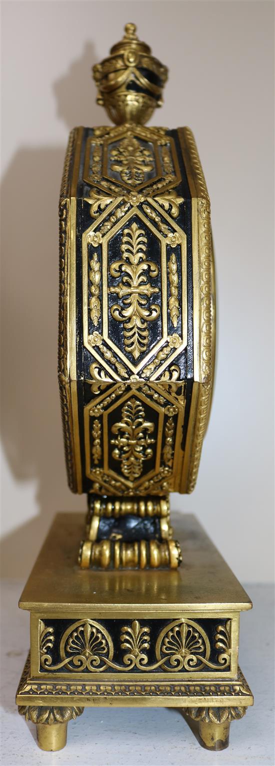 An early 20th century gilt and ebonised octagonal cased mantel clock retailed by Edward F. Caldwell & Co, New York, 13.75in.